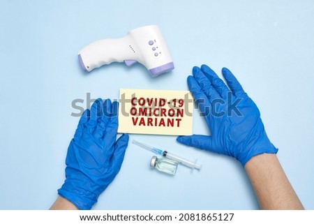 Doctor hand holds a card with text - New covid variant Omicron. Covid-19 new variant - Omicron. Omicron variant of coronavirus. SARS-CoV-2 variant of concern Royalty-Free Stock Photo #2081865127