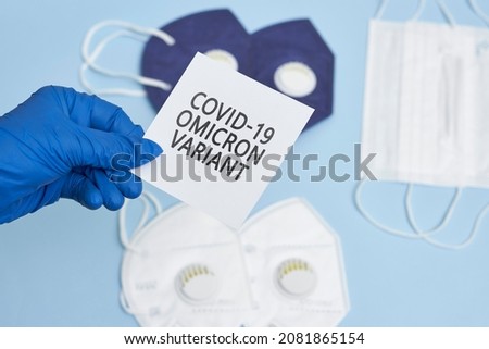 Doctor hand holds a card with text - New covid variant Omicron. Covid-19 new variant - Omicron. Omicron variant of coronavirus. SARS-CoV-2 variant of concern Royalty-Free Stock Photo #2081865154