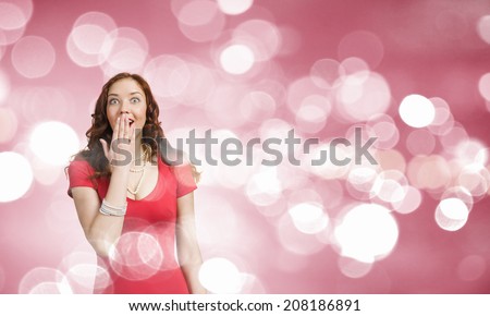 Young pretty girl in red dress against bokeh background