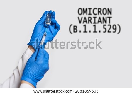 A doctor holds vaccine against new covid-19 omicron variant. New generation vaccine against Coronavirus South African variant. Omicron variant of SARS-CoV-2. New B.1.1.529 Variant of concern Royalty-Free Stock Photo #2081869603