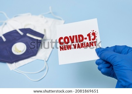 Doctor hand holds a card with text - New covid variant Omicron. Covid-19 new variant - Omicron. Omicron variant of coronavirus. SARS-CoV-2 variant of concern Royalty-Free Stock Photo #2081869651