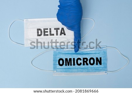 Female doctor holds a face mask with - Omicron variant text on it. Covid-19 new variant - Omicron. Omicron variant of coronavirus. SARS-CoV-2 variant of concern