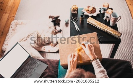 woman at home with dog hygge at Christmas time