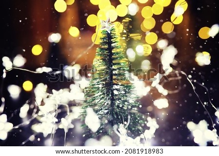 Christmas and New Year holiday background copy space. Winter holiday background with frozen fir, glitter lights, bokeh.
