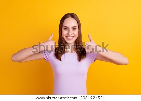 Photo of young lovely woman show thumb-up approve quality promotion isolated over yellow color background