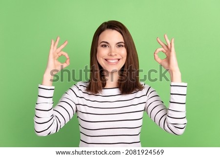 Photo of young pretty lady good mood show fingers okey symbol ads isolated over green color background