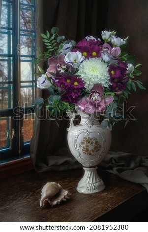 Still life with a luxurious bouquet in an antique vase