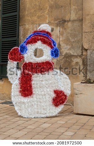 Close-up of an urban Christmas decoration, where you can take a picture with a snowman costume