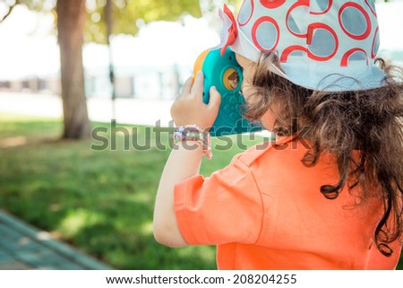 Little girl makes photos child camera 