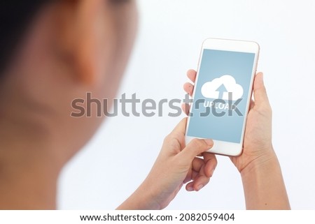 Smartphone on hand opening cloud uploading concept on phone screen. woman or man hand upload from mobile phone to store data on server.