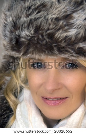 Portrait of beautiful blonde girl wearing fur