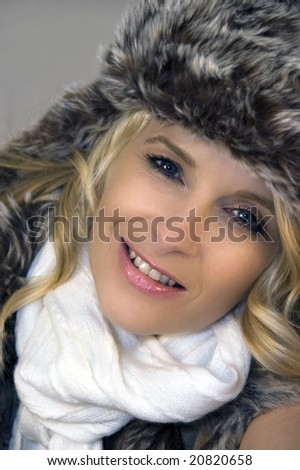 Portrait of beautiful blonde girl wearing fur