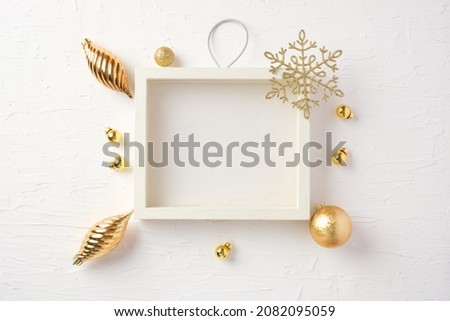 Christmas white picture frame and bauble,gift box,star decoration ornament on white concrete table