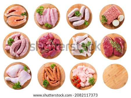 set of various fresh meat products on wooden boards isolated on white background, top view