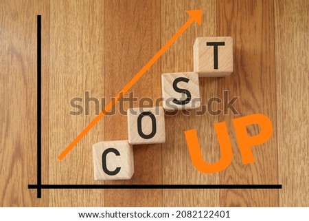 This is a concept photo about increasing costs. Wooden blocks.