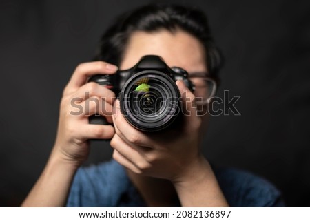 photographer take pictures Snapshot with camera. man hand holding with camera looking through lens.Concept for photographing articles Professionally.	