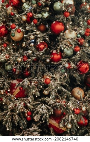 Christmas tree decorated with red festive Christmas balls. Fairy festive background for greeting postcard