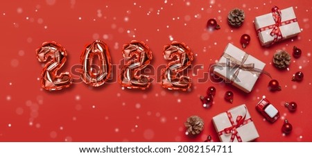 Xmas and Happy new year red 2022 numbers with snowflake, color trendy festive decorations on blue background. Greeting card, Holiday banner, web poster
