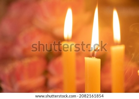 The yellow candles were burning brightly at the feast.