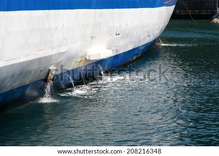 Water being pumped from the bilges of a boat. Royalty-Free Stock Photo #208216348