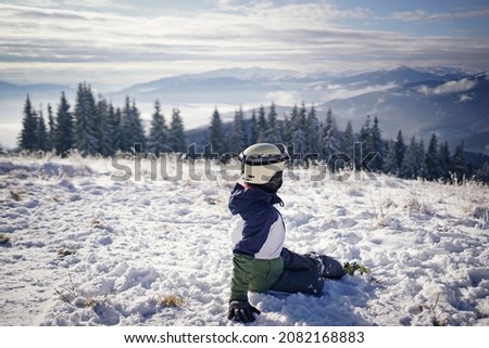Portrait of a young skier on a slope in the mountains