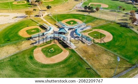 Aerial view huge baseballsoftball complex with natural grass fields, ticket offices, batting cages, pavilion, spectator seating Dallas, TX. Large sport facility venue for practice, tournaments Royalty-Free Stock Photo #2082209767