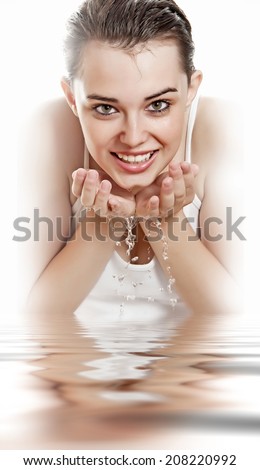young girl washing her face isolated on white background