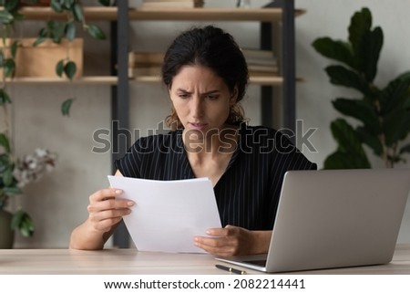 Worried unhappy latin businesswoman enterpreneur read paper letter about loan credit denial unexpected debt tax overdue. Stressed troubled woman employee thinking on business problem in bank notice Royalty-Free Stock Photo #2082214441