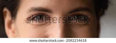 Close up cropped shot of young smiling woman face with beautiful eyes. Good vision and eye care. Contact lenses. Natural female beauty. Eye contour treatment cosmetic line. Wide horizontal web banner Royalty-Free Stock Photo #2082214618