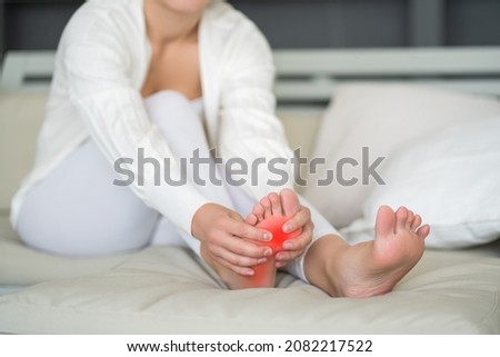 Joint diseases, hallux valgus, plantar fasciitis, heel spur, woman's leg hurts, pain in the foot, massage of female feet at home, health problems concept Royalty-Free Stock Photo #2082217522