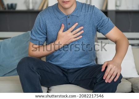 Chest pain and cough, man with lung ache at home, health problems concept Royalty-Free Stock Photo #2082217546