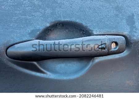 Picture of a frozen  grey car door handle