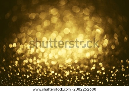 Golden glitter bokeh lighting texture Blurred abstract background for birthday, anniversary, wedding, new year eve or Christmas.