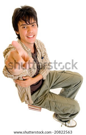 Handsome teenager boy student sitting on encyclopedia, casual dressed,  Studio shot, white background