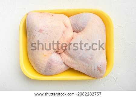 Fresh Chicken Whole Legs set, in Foam Tray Pack, on white stone  background, top view flat lay