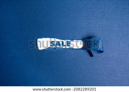 Blue torn paper whole with sale text promo