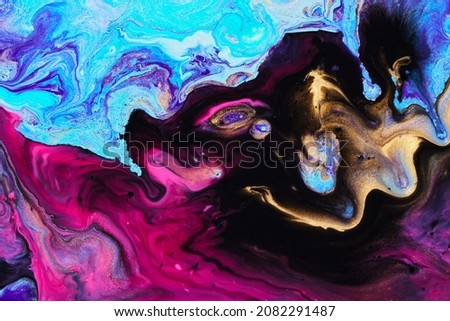 PHOTO of Bright creative texture made by floating paints. Macro photo of flowing inks