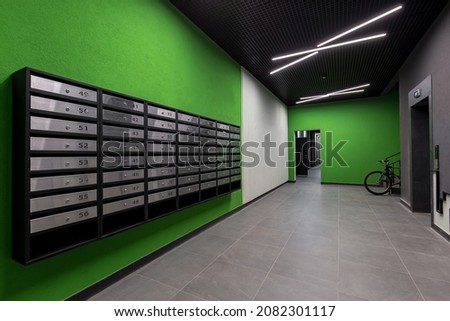 Corridor hall interior, with front door and elevator in many apartment building, with mailboxes with green walls Royalty-Free Stock Photo #2082301117