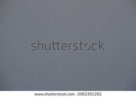 A plain grey stone background