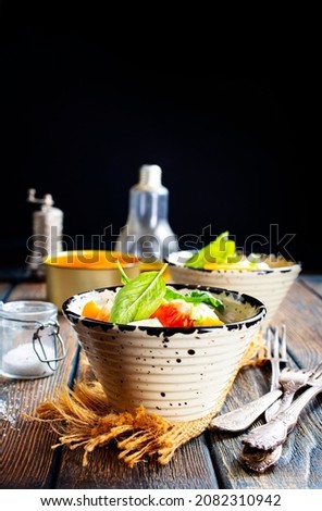 Tomato salad with basil, cheese, olive oil and garlic dressing Blue wooden background