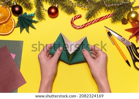 How to make origami Christmas tree from colored paper. Children's art project. DIY concept. Step 5. Now we add as shown in the picture.