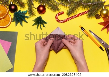 How to make origami Christmas tree from colored paper. Children's art project. DIY concept. Step 17. We fold it in the same way as before for the tree in a square and fold each side as in the picture