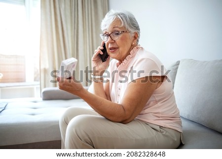 Senior women getting distance medical consultation. Close up of a senior woman consulting with her doctor online on her phone. Senior woman talking with a doctor about medication by phone.