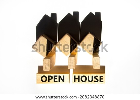 Open house symbol. Concept words 'Open house' on wooden blocks near miniature houses from shadows. Beautiful white background, copy space. Business and open house concept.