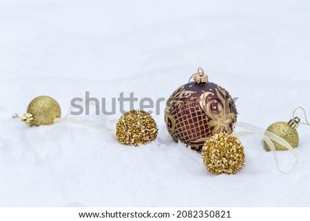 Golden Christmas balls on snow background, Christmas banner