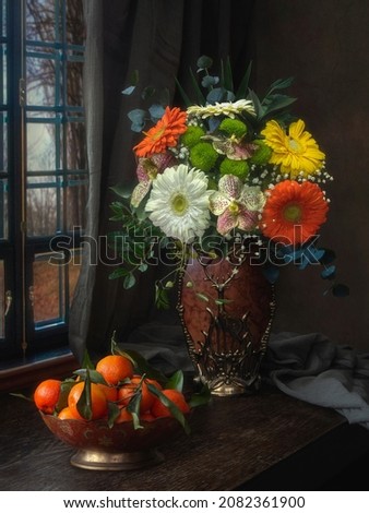 Still life with luxurious bouquet of flowers and tangerines
