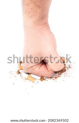 a human hand. the man on her hair. clenched into a fist, and a blow to the broken cigarettes. on a white background. close-up,