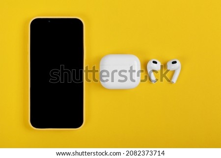 New Wireless apple AirPods 3 with Iphone 13 pro on yellow background