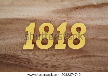 Golden Arabic numerals 1818 on a dark brown to white wood grain background.