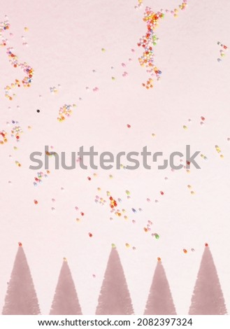 Christmas tree shadows on pastel pink background with multicolored party decoration. Christmas and new year celebration concept, flat lay composition.